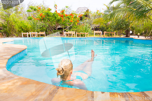 Image of Caucasian lady floating in swimming pool.