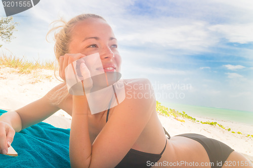 Image of Happy woman in bikini on the beach.