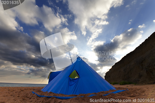 Image of Conical tent on summer beach in evening