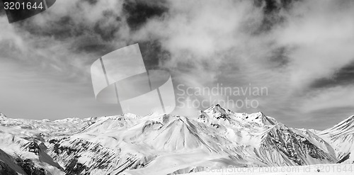 Image of Black and white snowy mountains at wind day