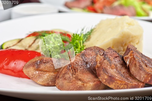 Image of tongue with grilled vegetable