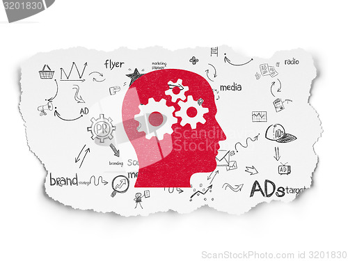 Image of Advertising concept: Head With Gears on Torn Paper background