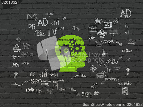 Image of Advertising concept: Head With Gears on wall background
