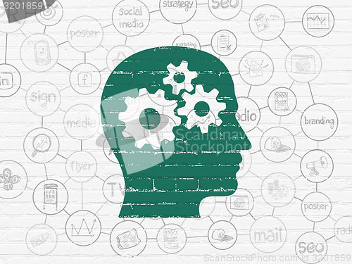 Image of Advertising concept: Head With Gears on wall background