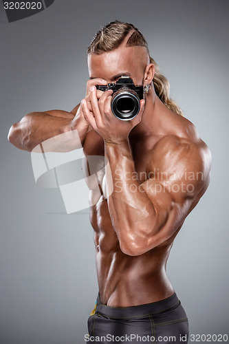 Image of Attractive male body builder on white background