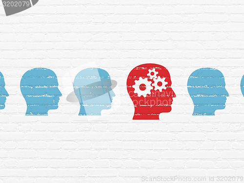 Image of Education concept: red head with gears icon on wall background