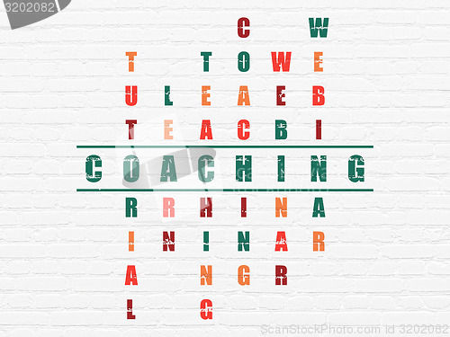 Image of Education concept: word Coaching in solving Crossword Puzzle