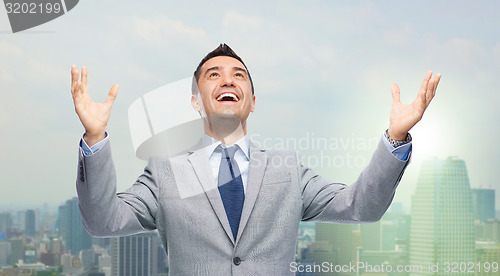 Image of happy laughing businessman in suit
