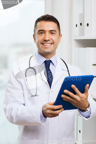 Image of smiling male doctor in white coat with tablet pc