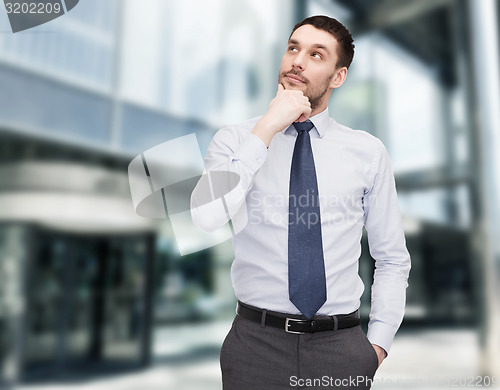 Image of handsome businessman looking up