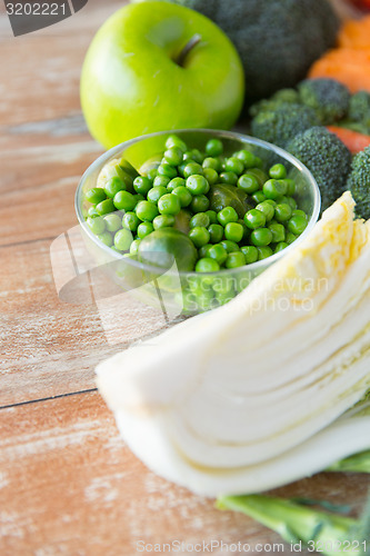 Image of close up of ripe vegetables on wooden table