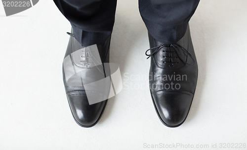 Image of close up of man legs in elegant shoes with laces