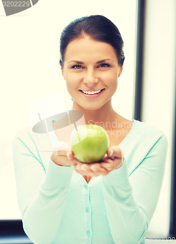Image of lovely housewife with green apple