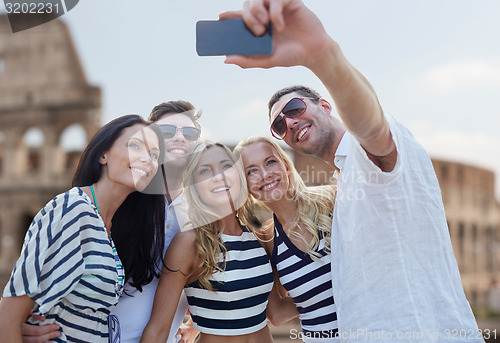 Image of friends taking selfie with smartphone