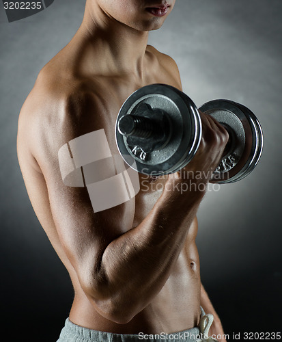 Image of young man with dumbbell