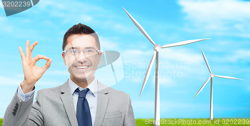 Image of happy smiling businessman in eyeglasses and suit