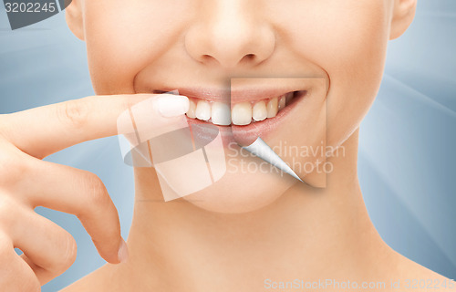 Image of beautiful woman pointing to teeth