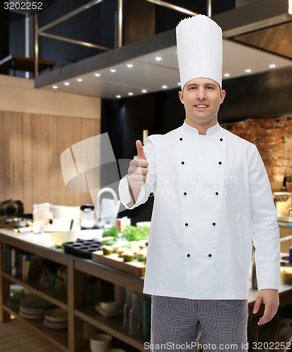 Image of happy male chef cook showing thumbs up