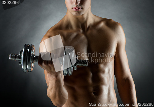 Image of young man with dumbbell