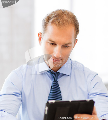 Image of businessman with tablet pc in office