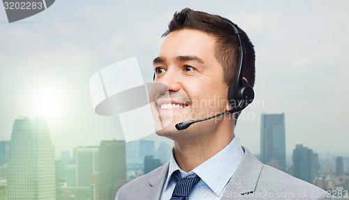 Image of smiling businessman in headset