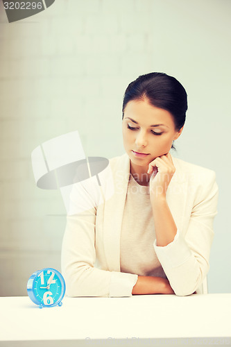 Image of businesswoman with clock