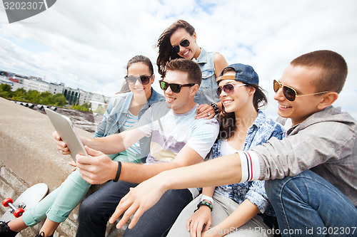 Image of group of teenagers looking at tablet pc