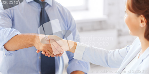 Image of business people shaking hands in office