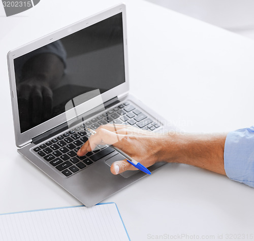 Image of miling businessman working in office