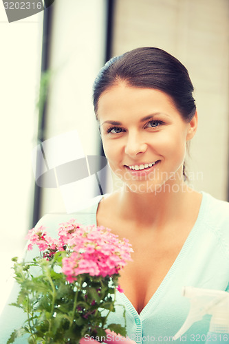 Image of lovely housewife with flower