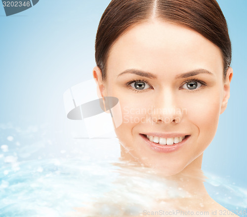 Image of face of beautiful young woman and water splash
