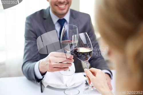 Image of happy couple with glasses of wine at restaurant