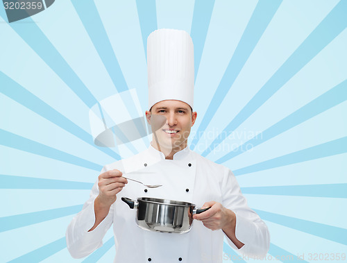 Image of happy male chef cook with pot and spoon