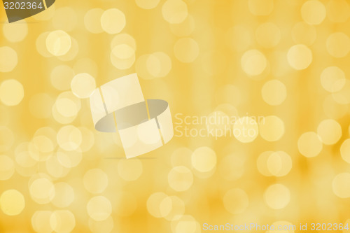 Image of blurred golden background with bokeh lights