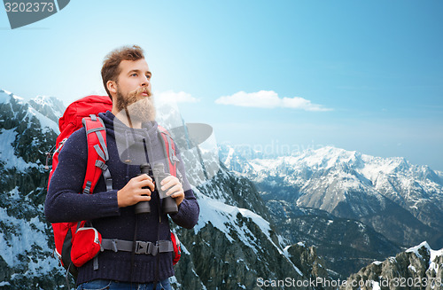 Image of man with backpack and binocular outdoors