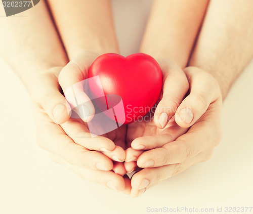 Image of woman and man hands with heart