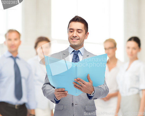 Image of happy businessman with open folder