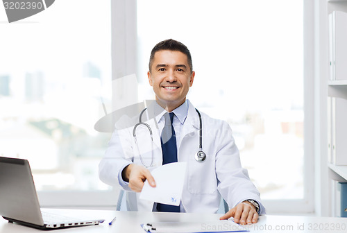 Image of happy doctor with prescription and laptop