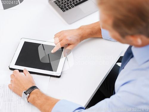 Image of businessman with tablet pc in office