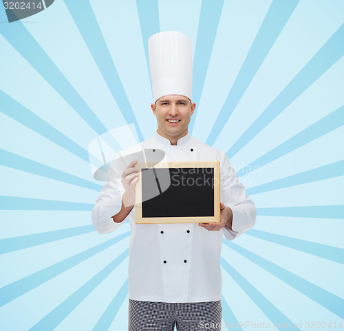 Image of happy male chef cook holding blank menu board