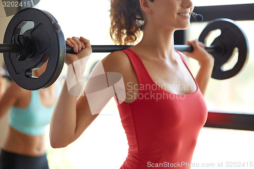 Image of group of women with barbells working out in gym