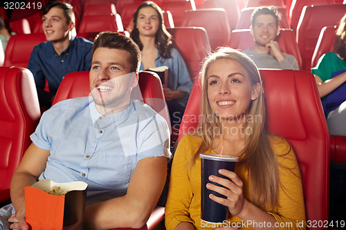 Image of happy friends watching movie in theater