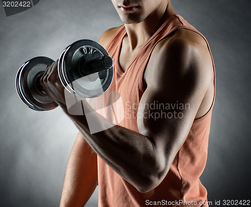 Image of young man with dumbbell