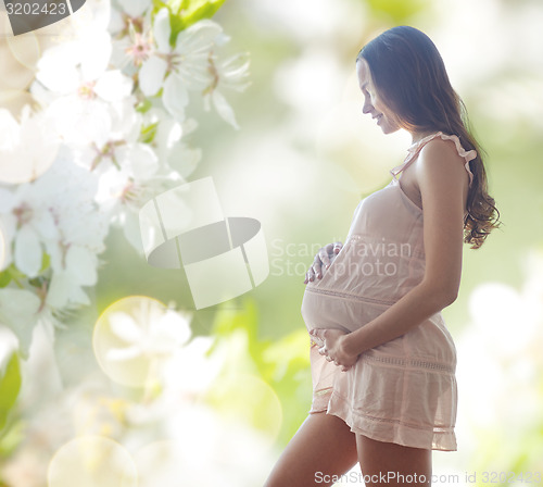 Image of happy pregnant woman in chemise