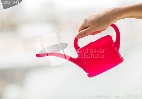 Image of close up of woman hand holding watering can