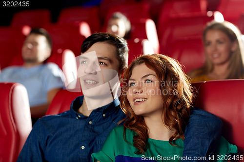 Image of happy friends watching movie in theater
