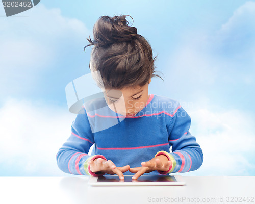 Image of little girl with tablet pc over sky background