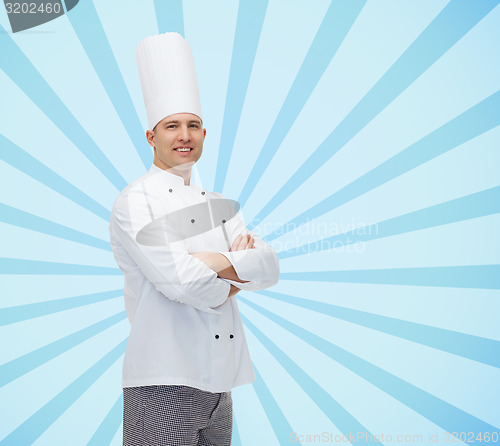 Image of happy male chef cook with crossed hands