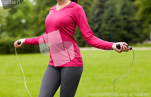 Image of close up of woman exercising with jump-rope