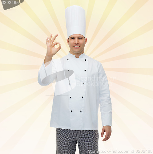 Image of happy male chef cook showing ok sign